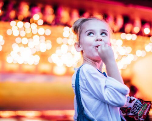 young-girl-eating-lolly-at-movie-world